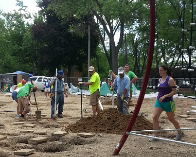 Hard working volunteers assembling and installing new playground equipment