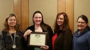 Montgomery Smith pictured holding her Students of the Month award